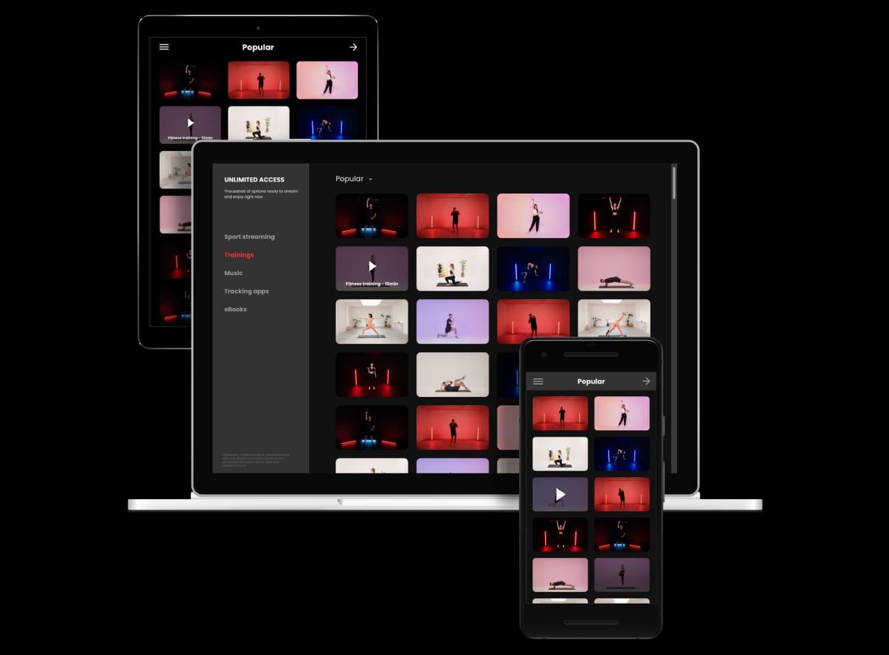 A woman streaming a guided workout at home on a tablet